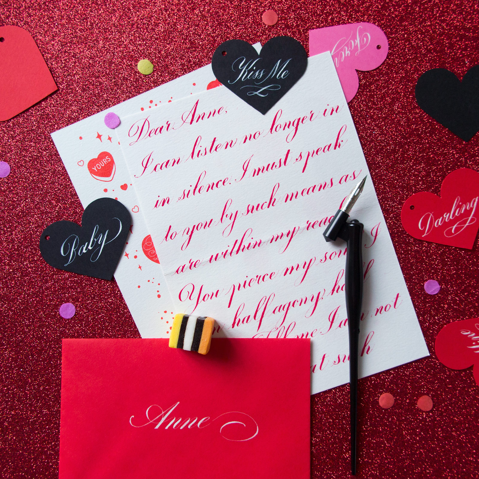 Editorial shot of letter with calligraphy and heart tags